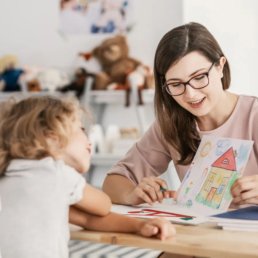 A therapist and child drawing together during an individual session
