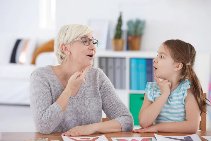 A therapist supporting a child’s communication skills