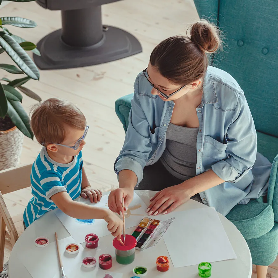 A child and therapist painting together