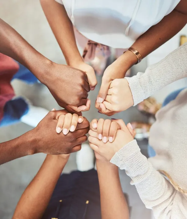 A group offering support by holding hands